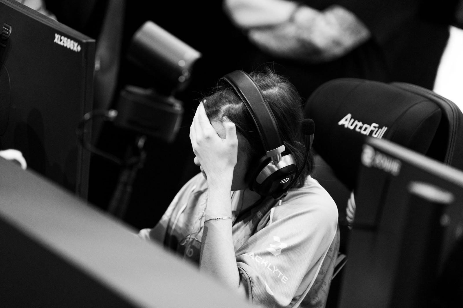 Facepalming after the match, greyscale